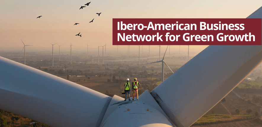 Engineers standing on a wind turbine looking out across the landscape